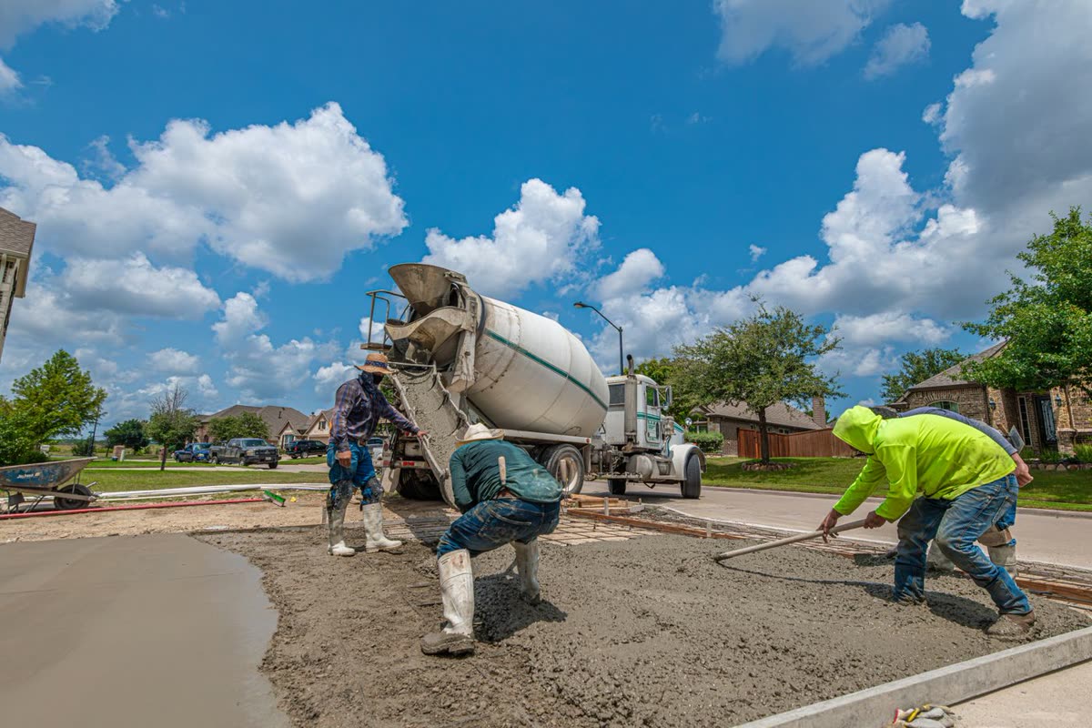 Concrete truck discharging during a driveway replacement pour